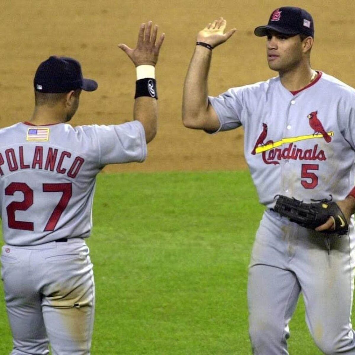 Albert Pujols and Placido Polanco high-five during the 2001 season with the St. Louis Cardinals.