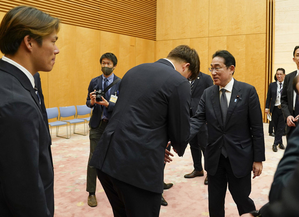 Japanese Prime Minister Fumio Kishida, center right, meets Japan's World Baseball Classic team's slugger Munetaka Murakami, center left, and pitcher Yoshinobu Yamamoto, left, at the latter's official residence in Tokyo, Japan, Thursday, March 23, 2023