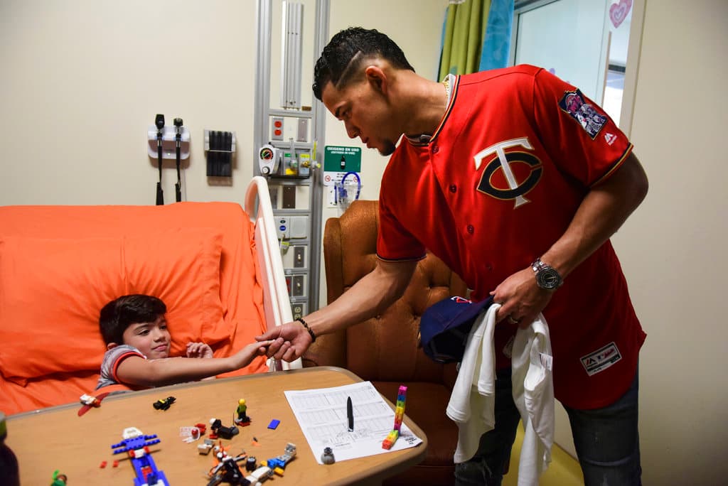 Title: Puerto Rico Baseball Image ID: 18106742926504 Article: Minnesota Twins starting pitcher Jose Berrios shakes the hand of 7-year-old Lucas Suarez, during a visit by a group of Berrios' teammates at the San Jorge Children's Hospital in San Juan, Puerto Rico, Monday, April 16, 2018. Next Tuesday and Wednesday, the Cleveland Indians and the Minnesota Twins will meet in a two-game series at Hiram Bithorn Stadium in San Juan. (AP Photo/Carlos Giusti)
