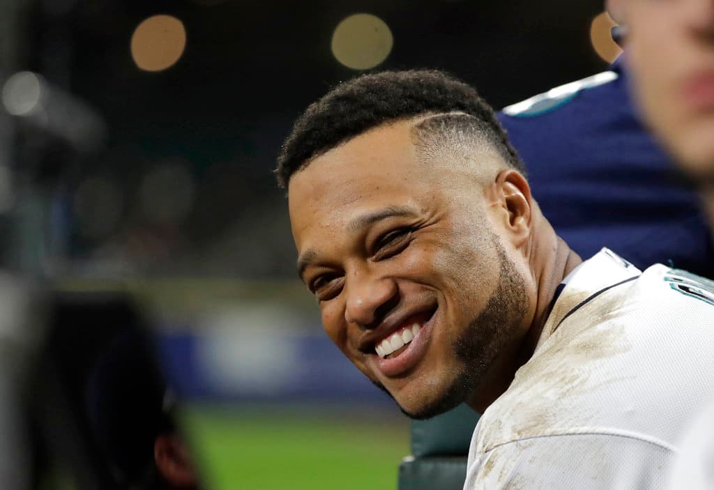 Title: Astros Mariners Baseball Image ID: 18107127540008 Article: Seattle Mariners' Robinson Cano smiles in the dugout during a baseball game against the Houston Astros, Monday, April 16, 2018, in Seattle. (AP Photo/Ted S. Warren)