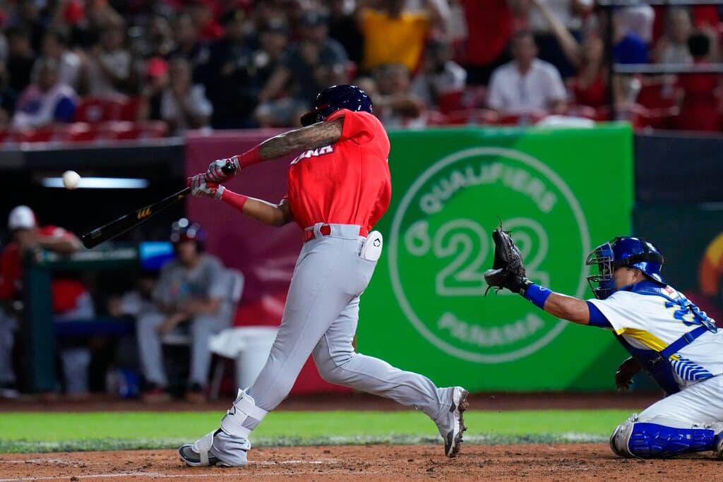 Title: Panama WBC Baseball Image ID: 22278092682042 Article: Panama's Jose Ramos hits a two-run home run during the 4th inning against Brazil of a World Baseball Classic qualifying game at the Rod Carew National Stadium in Panama City, Tuesday, Oct. 4, 2022. (AP Photo/Arnulfo Franco)