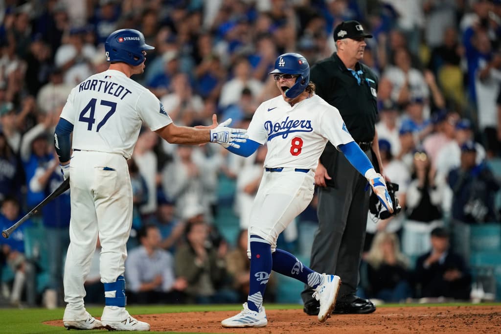Title: Reds Dodgers Baseball Image ID: 25275084745089 Article: Los Angeles Dodgers' Kiké Hernández celebrates with Ben Rortvedt (47) after scoring on a single by Miguel Rojas during the fourth inning in Game 2 of the National League Wild Card baseball playoff series against the Cincinnati Reds, Wednesday, Oct. 1, 2025, in Los Angeles. (AP Photo/Mark J. Terrill)