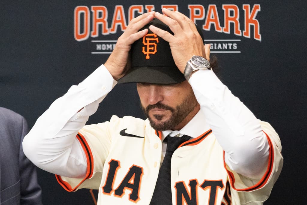 Title: Giants Vitello Baseball Image ID: 25303696261227 Article: Tony Vitello dons a baseball cap as he is introduced as the new manager of the San Francisco Giants baseball team, Thursday, Oct. 30, 2025, in San Francisco. (AP Photo/Benjamin Fanjoy)