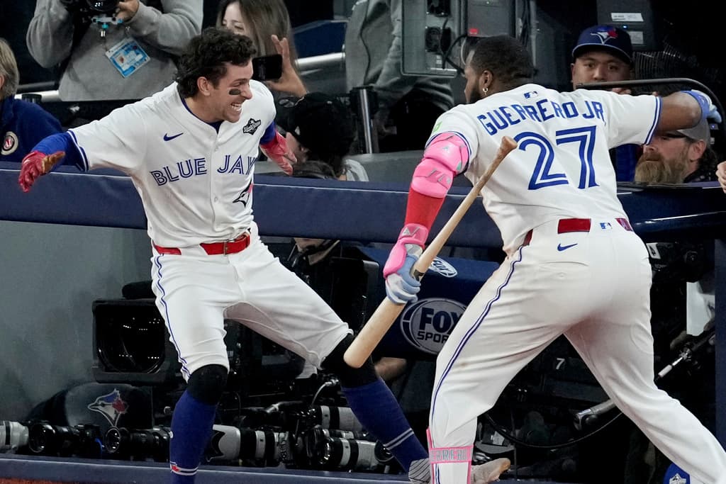 Title: World Series Dodgers Blue Jays Baseball Image ID: 25306089483115 Article: Toronto Blue Jays' Ernie Clement celebrates with Vladimir Guerrero Jr. (27) after scoring on a double by Andrés Giménez during the sixth inning in Game 7 of baseball's World Series against the Los Angeles Dodgers, Saturday, Nov. 1, 2025, in Toronto. (AP Photo/Ashley Landis)