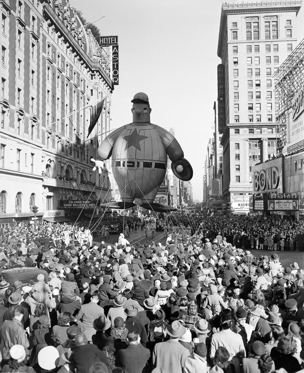 Title: Thanksgiving Day Parade Image ID: 461128029 Article: A giant baseball player float moves down 7th Avenue during the Macy' Thanksgiving Day Parade on Nov. 28, 1946. (AP Photo/John Rooney)