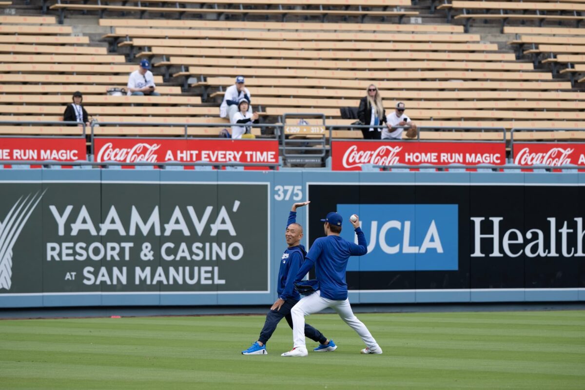 Osamu Yada is a 66-year-old judo therapist from Osaka and the longtime personal trainer behind Yoshinobu Yamamoto’s unconventional development. Director of Yada Judo Therapy Clinic, he treats bone, joint, and soft-tissue injuries while overseeing Yamamoto’s daily program, often five to six hours of work built around “BC Exercises” rather than traditional weightlifting. Yada’s philosophy is that performance begins with posture and movement: if you can’t stand, walk, and run correctly, you can’t throw correctly. His 5B Method—Breath, Bar, Bowl, Board, Bridge—uses hundreds of combinations to activate inner muscles and restore natural motion. He also created the “Javelic Throw,” a javelin-based drill that promotes full-body throwing and reduces arm stress. Yamamoto credits Yada with transforming him from an exhausted, elbow-sore prospect into a pitcher capable of deep outings and rapid recovery. Quiet, strict, and often jokingly compared to a sensei or Yoda, Yada has become a cult figure among Dodgers fans.