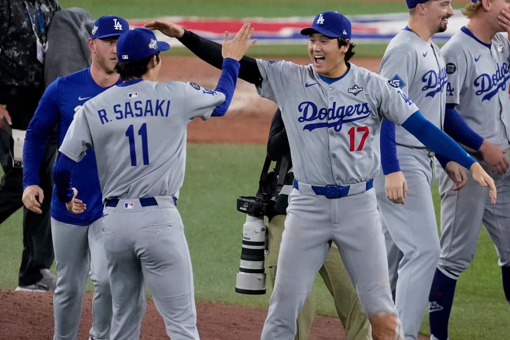 Title: World Series Dodgers Blue Jays BaseballImage ID: 25306161587517 Article: Los Angeles Dodgers' Shohei Ohtani (17) and Roki Sasaki (11) celebrate their teams' win in Game 7 of baseball's World Series agaisnt the Toronto Blue Jays, Sunday, Nov. 2, 2025, in Toronto. (AP Photo/Ashley Landis)