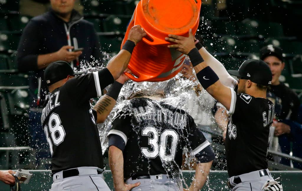 Title: White Sox Mariners Baseball Image ID: 17140184241186 Article: Chicago White Sox closing pitcher David Robertson (30) is doused by teammates Omar Narvaez (38) and Yolmer Sanchez, right, after Robertson earned the win as the White Sox beat the Seattle Mariners 2-1 in ten innings, Friday, May 19, 2017, in Seattle. (AP Photo/Ted S. Warren)