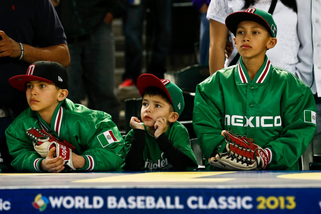 Title: WBC Mexico United States Baseball Image ID: 130308026579 Article: Mexico baseball fans watch their team warm up prior to a World Baseball Classic baseball game between Mexico and the United States on Friday, March 8, 2013, in Phoenix. Mexico defeated the United States 5-2. (AP Photo/Ross D. Franklin)