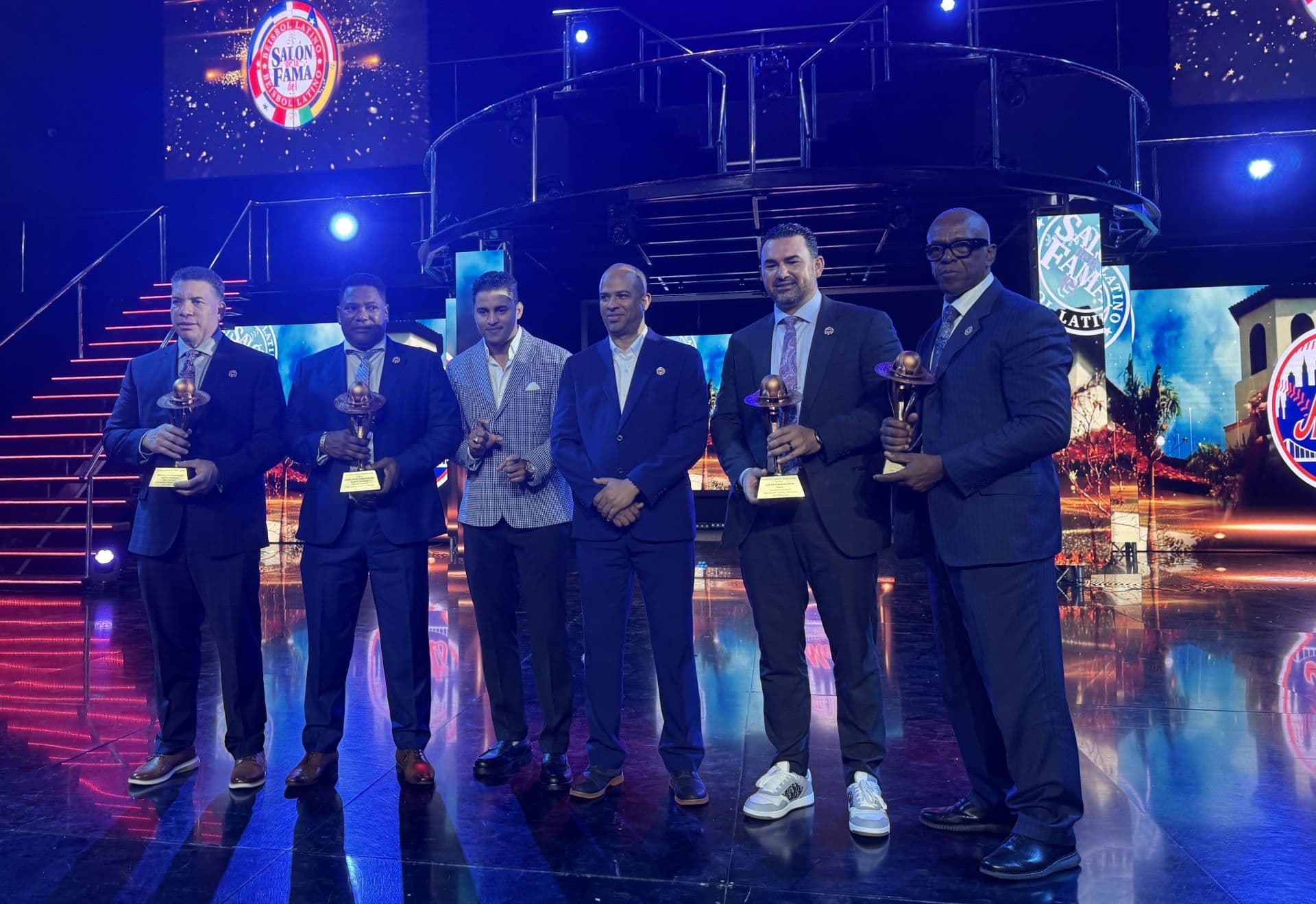 Bartolo Colón, Miguel Tejada, Adrián González, and Julio Franco holding trophies during the 2026 induction ceremony in Punta Cana.