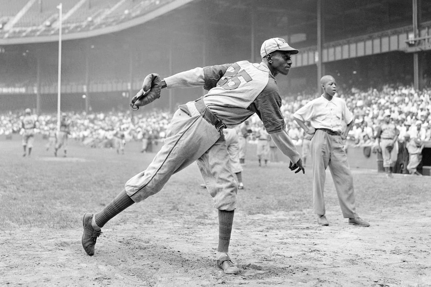 Satchel Paige warming up at Yankee Stadium before a Negro League game in 1942