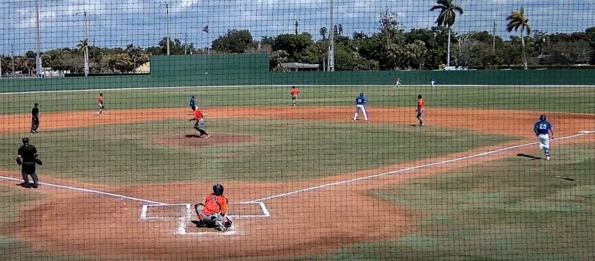 Netherlands center fielder and Italy corner outfielder converge on a fly ball in right-center at Terry Park.