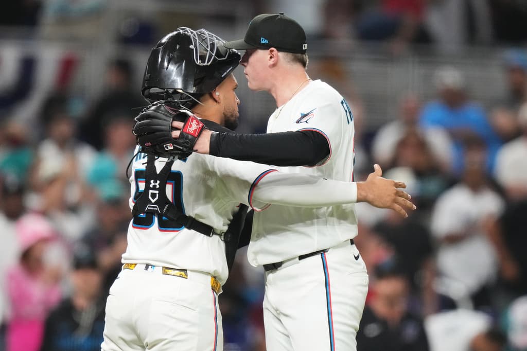 Miami Marlins catcher Agustín Ramírez and pitcher Pete Fairbanks celebrate after closing out a 2–1 Opening Day win over the Colorado Rockies