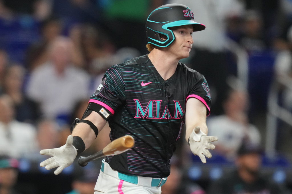Miami Marlins' Owen Caissie drops his bat after hitting a double during the second inning of a baseball game against the Colorado Rockies, Saturday, March 28, 2026, in Miami. (AP Photo/Lynne Sladky)