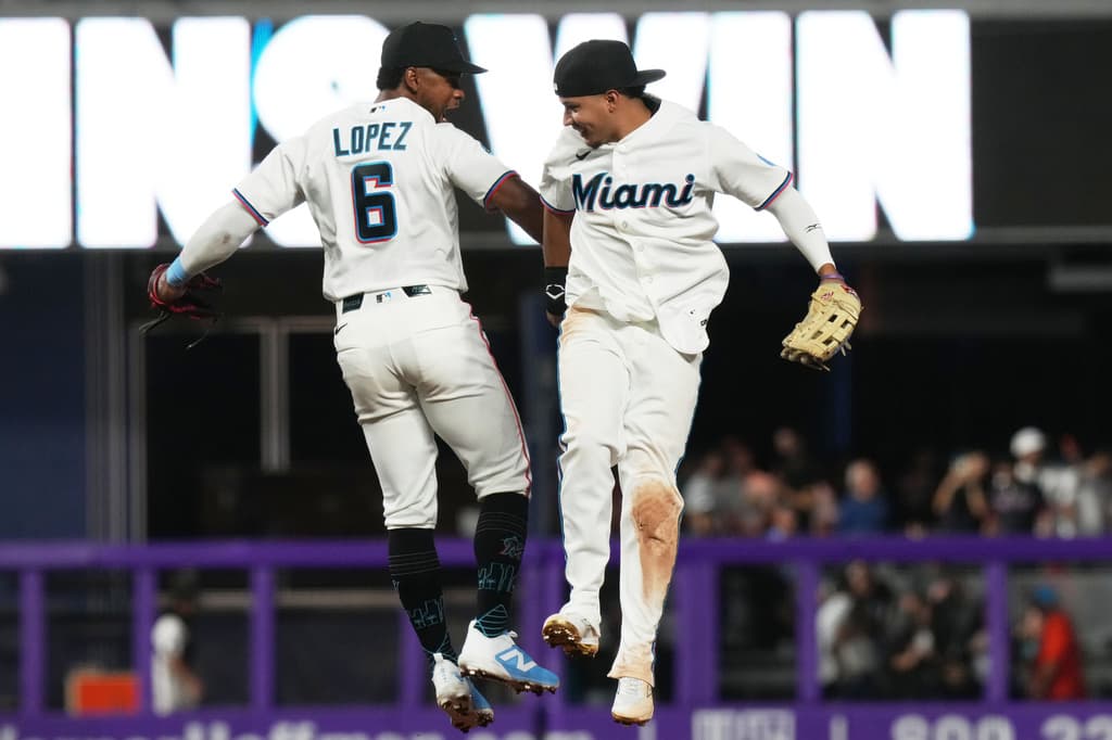 Miami Marlins players Otto Lopez and Javier Sanoja celebrate after defeating the Colorado Rockies on MLB Opening Day at loanDepot park in Miami