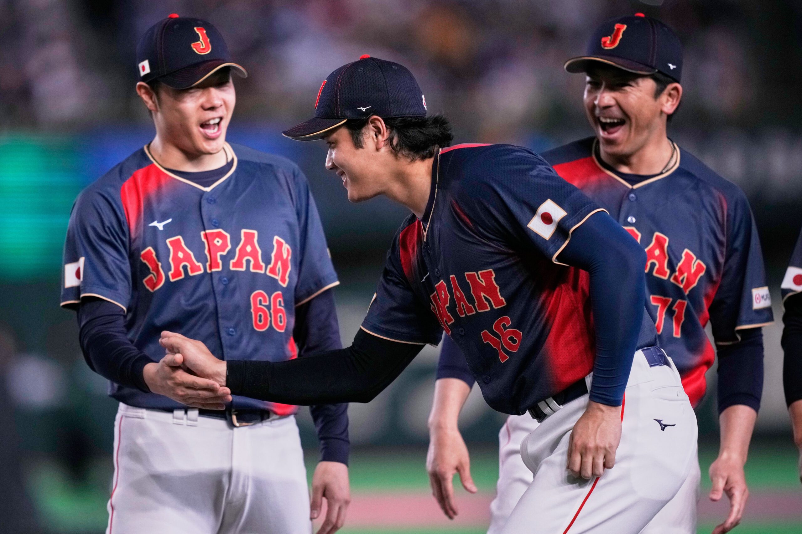 Japan's Shohei Ohtani, center, greets teammate Yuki Matsumoto as he arrives before the start of a World Baseball Classic Pool C game between Japan and Taiwan Friday, March 6, 2026 in Tokyo. (AP Photo/Louise Delmotte)