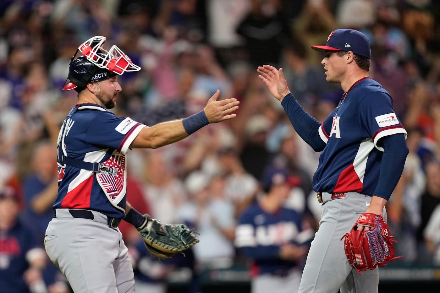 Team USA catcher Cal Raleigh and pitcher Mason Miller celebrate with a handshake after a 5–3 World Baseball Classic quarterfinal win over Canada in Houston.