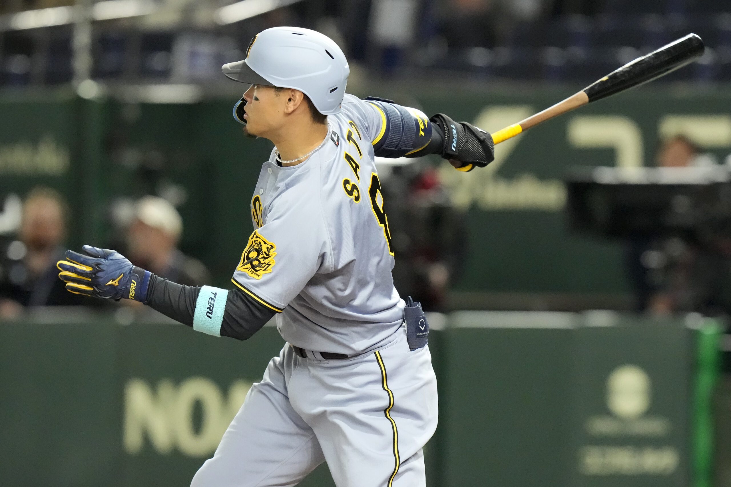 Hanshin Tigers' Teruaki Sato grounds out against the Chicago Cubs during the third inning of a spring training baseball game in Tokyo, Saturday, March 15, 2025. (AP Photo/Eugene Hoshiko)
